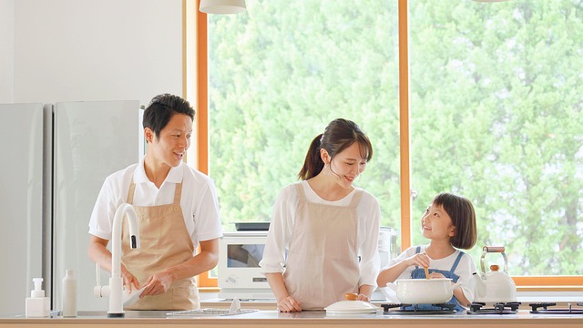 A father and mother talking with their young daughter in a bright home kitchen